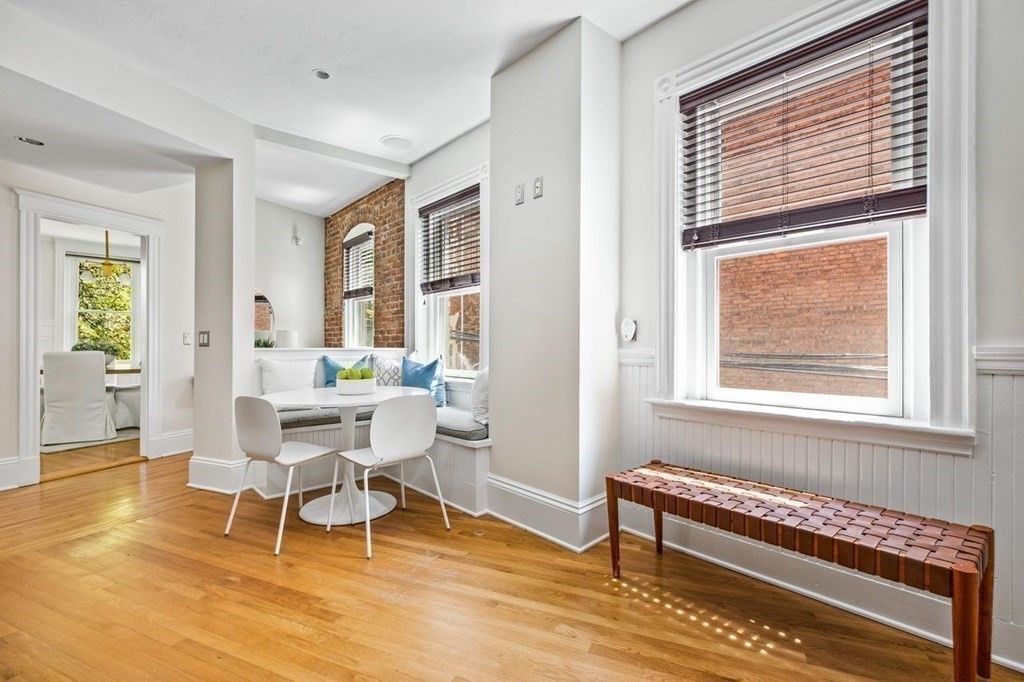 1 Clinton Path, Unit 2 Brookline, MA 02445 - Photo 14 of 28 a dining room with wooden floor and a window