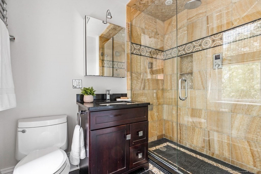 1 Clinton Path, Unit 2 Brookline, MA 02445 - Photo 22 of 28 a bathroom with a granite countertop sink toilet and shower