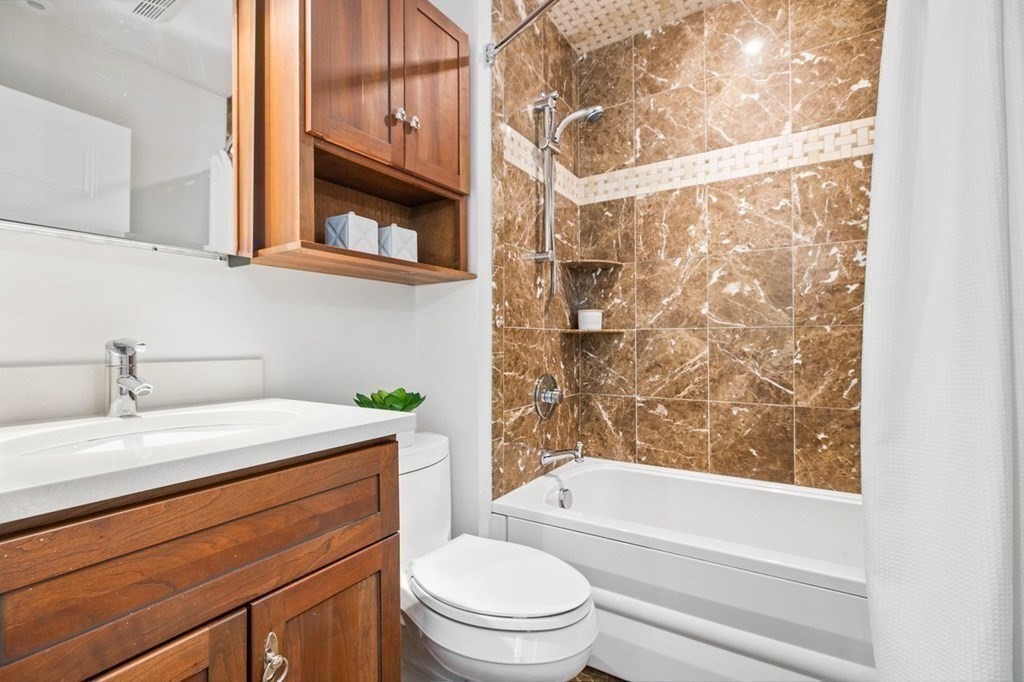 1 Clinton Path, Unit 2 Brookline, MA 02445 - Photo 27 of 28 a bathroom with a sink a toilet and a bathtub