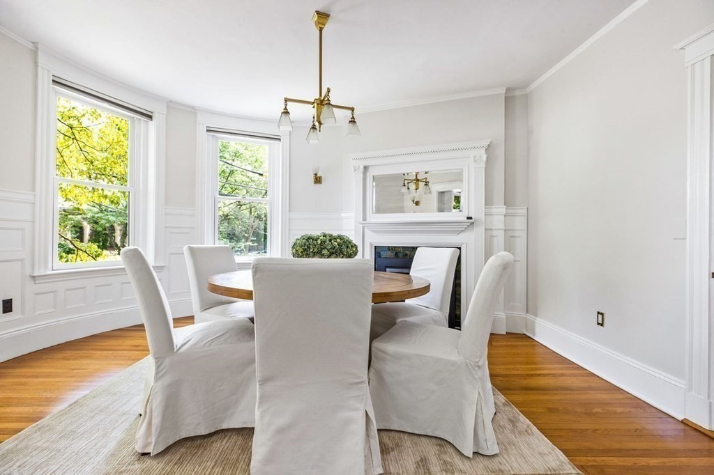 1 Clinton Path, Unit 2 Brookline, MA 02445 - Photo 8 of 28 a view of a dining room with furniture a chandelier and wooden floor