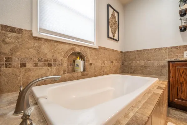 a bathroom with a tub and a sink