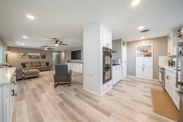 a view of a living room kitchen and a wooden floor