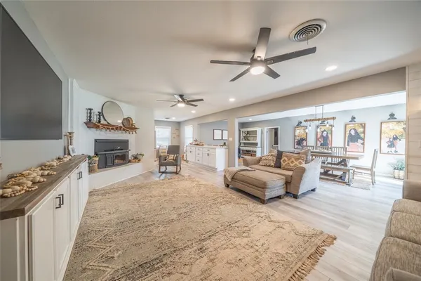 a spacious bedroom with furniture and a fireplace