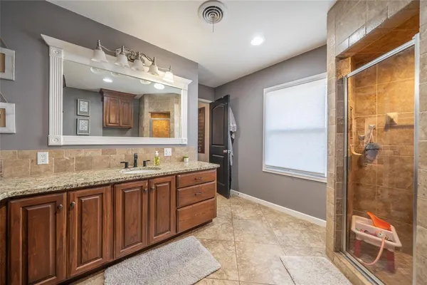a bathroom with a double vanity sink and a mirror