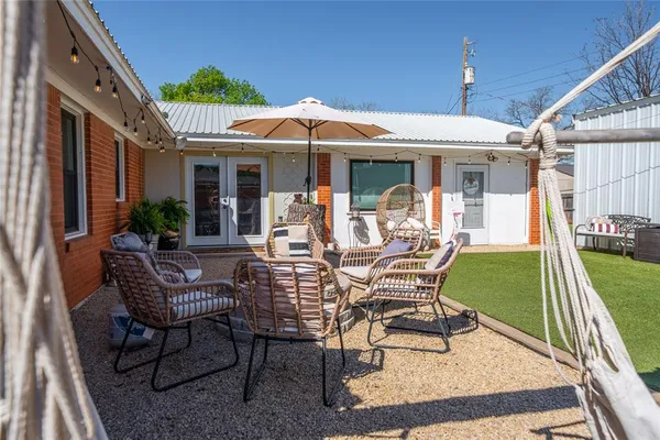 a view of a house with backyard porch and sitting area