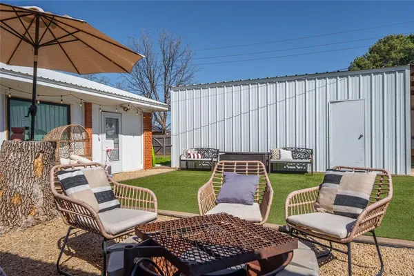 a view of a backyard with furniture
