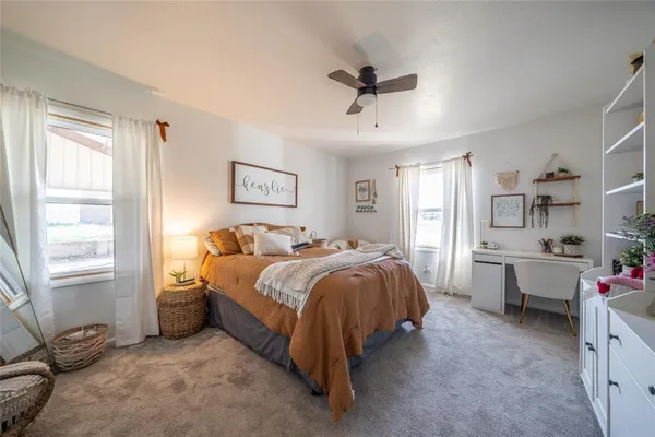 a spacious bedroom with a bed and a window