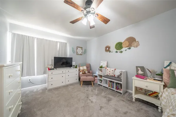 a bedroom with furniture and a flat screen tv