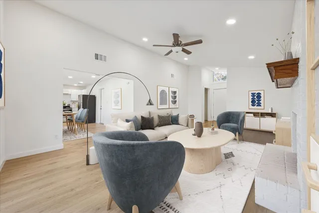 a living room with fireplace furniture and a wooden floor