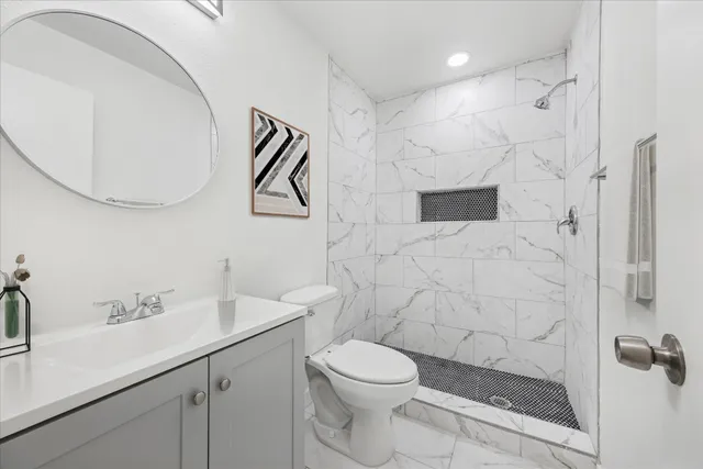 a bathroom with a toilet sink and shower