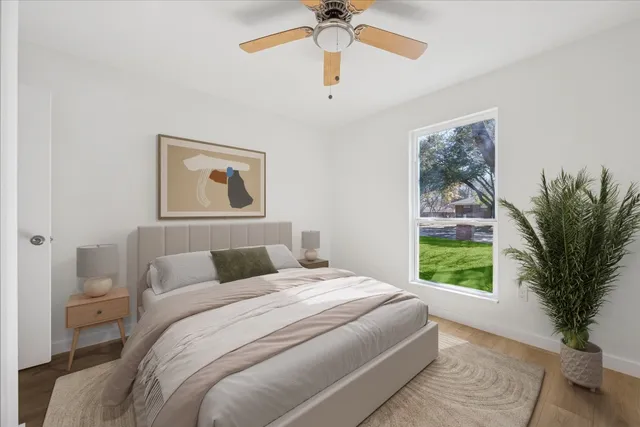 a bedroom with a large bed and a window