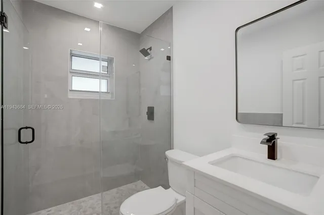 an empty room with chandelier fan