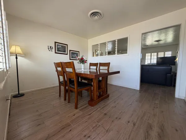 a living room with furniture a ceiling fan and a rug