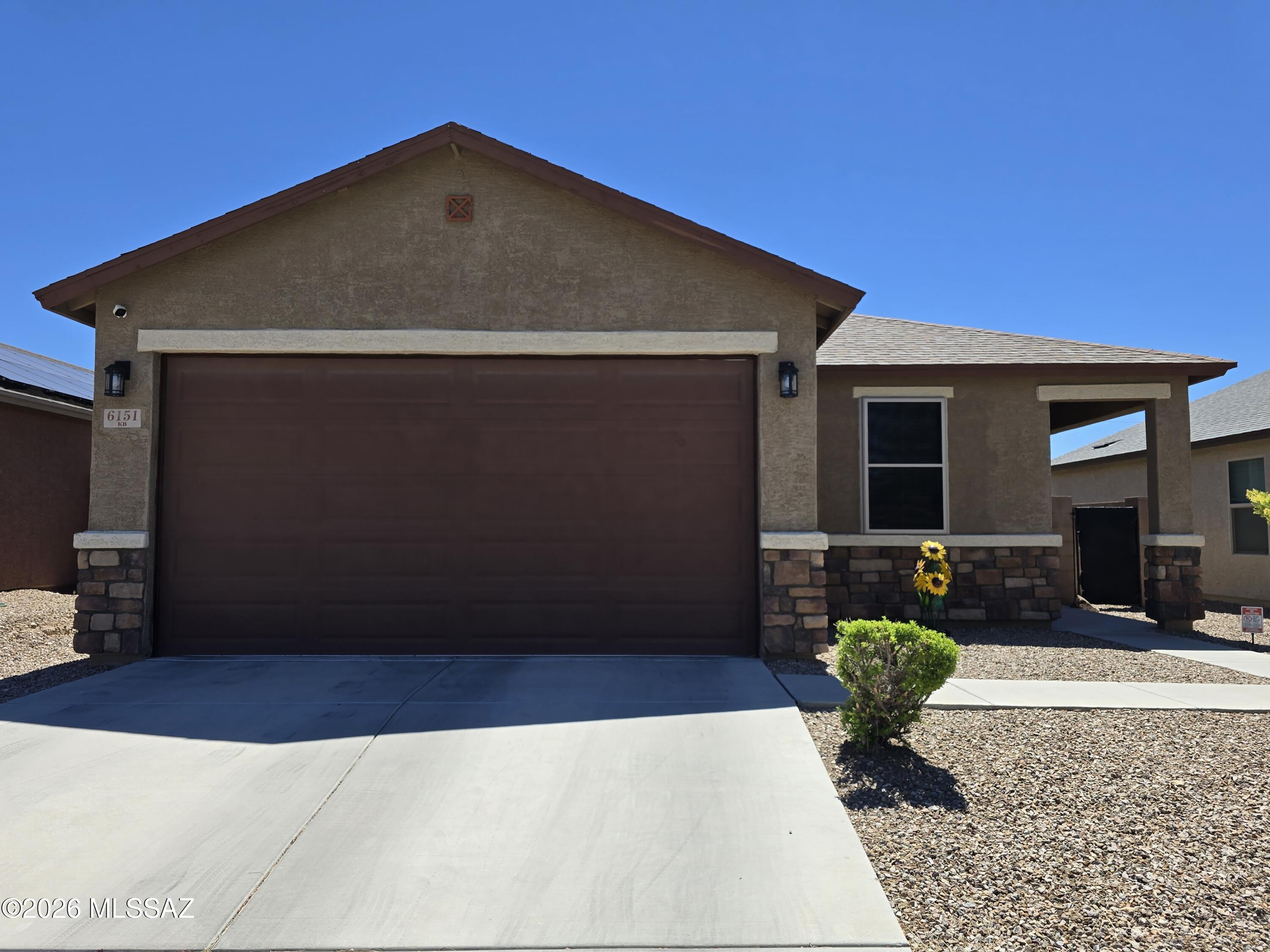 6151 South Antrim Loop Tucson, AZ 85706 - Photo 2 of 13 a front view of a house with garden