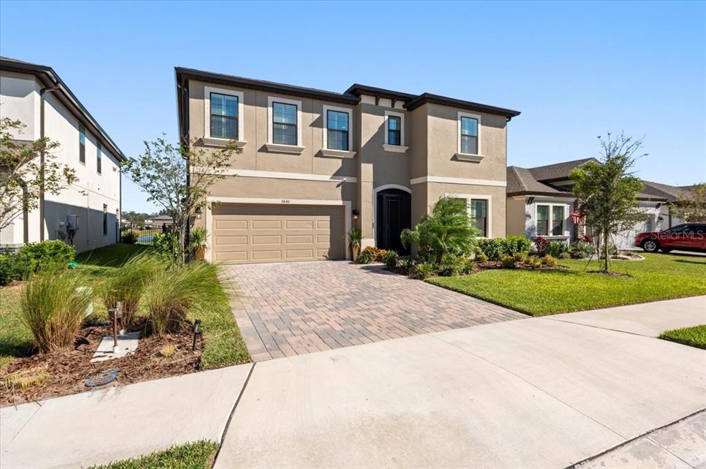 a front view of a house with a yard and garage