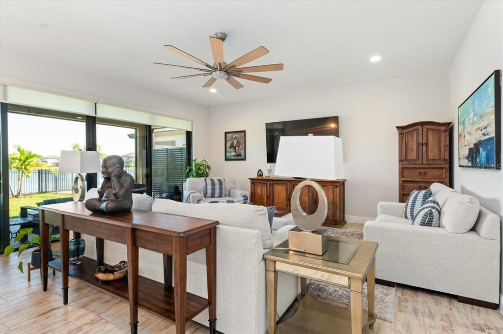 7440 Rhubarb Drive Parrish, FL 34219 - Photo 12 of 59 a living room with furniture and a large window