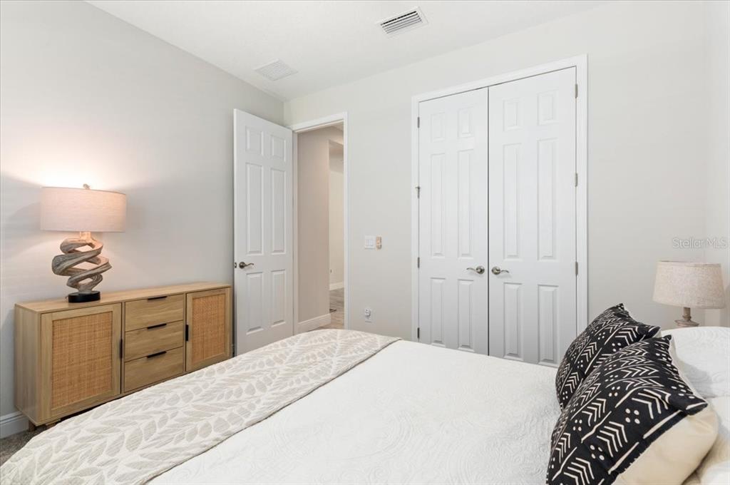 7440 Rhubarb Drive Parrish, FL 34219 - Photo 22 of 59 a bedroom with a bed and a lamp