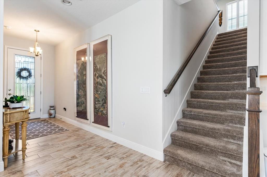 7440 Rhubarb Drive Parrish, FL 34219 - Photo 25 of 59 a view of an entryway with wooden floor and windows