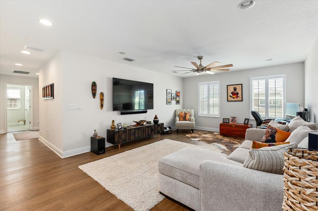 7440 Rhubarb Drive Parrish, FL 34219 - Photo 29 of 59 a living room with furniture and a flat screen tv