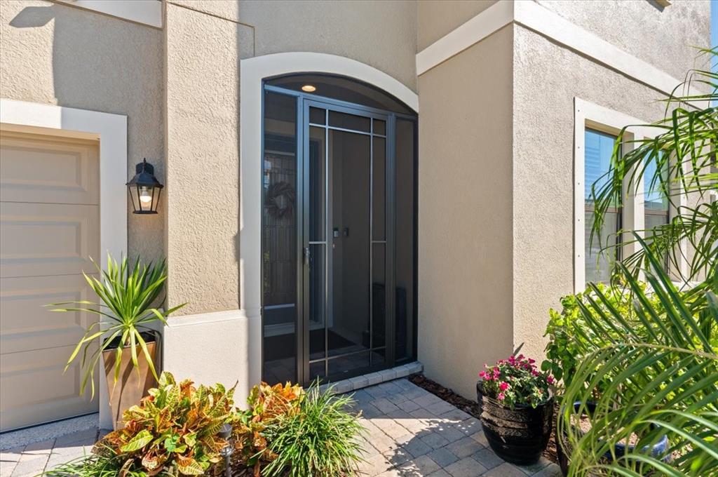 7440 Rhubarb Drive Parrish, FL 34219 - Photo 3 of 59 a potted plant sitting in front of a house