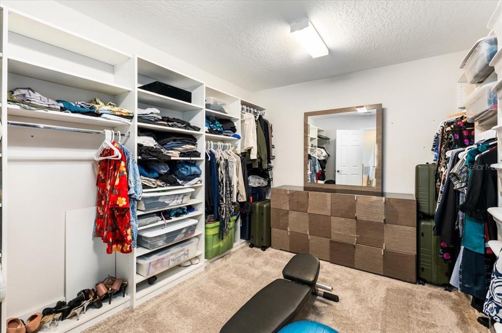 7440 Rhubarb Drive Parrish, FL 34219 - Photo 36 of 59 a view of walk in closet with clothes and shoes