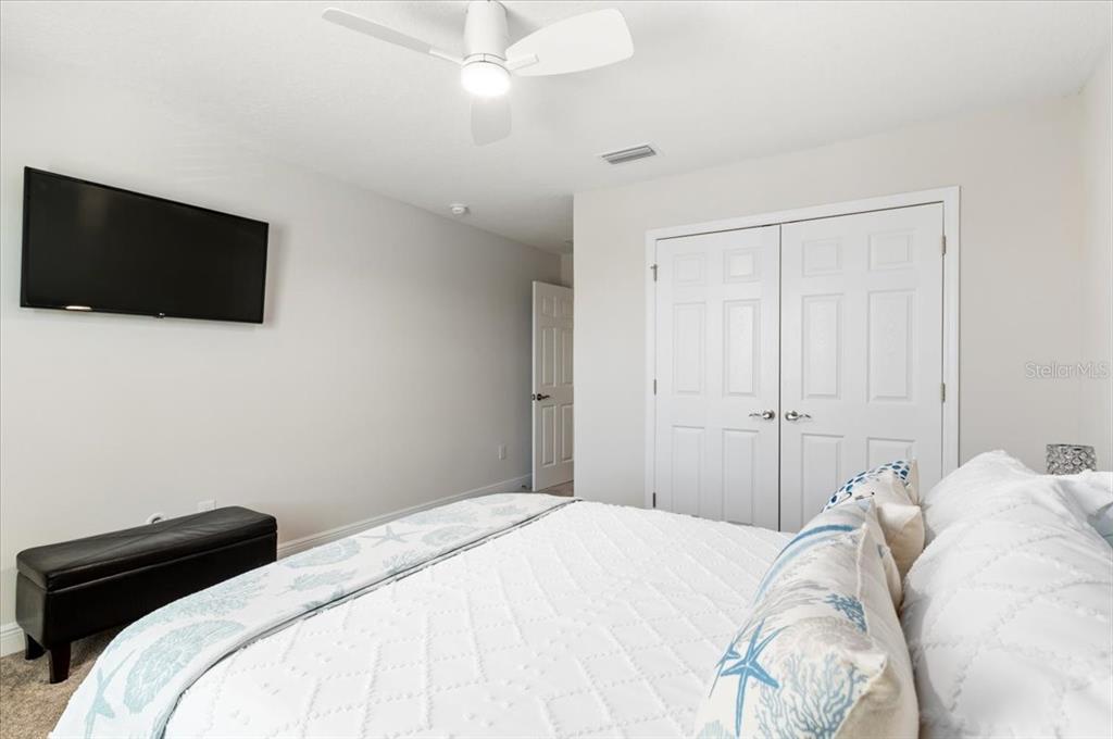 7440 Rhubarb Drive Parrish, FL 34219 - Photo 38 of 59 a bedroom with a bed and a flat screen tv