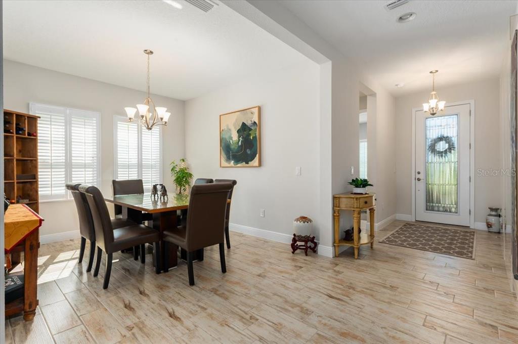 7440 Rhubarb Drive Parrish, FL 34219 - Photo 9 of 59 a view of a dining room with furniture window and wooden floor