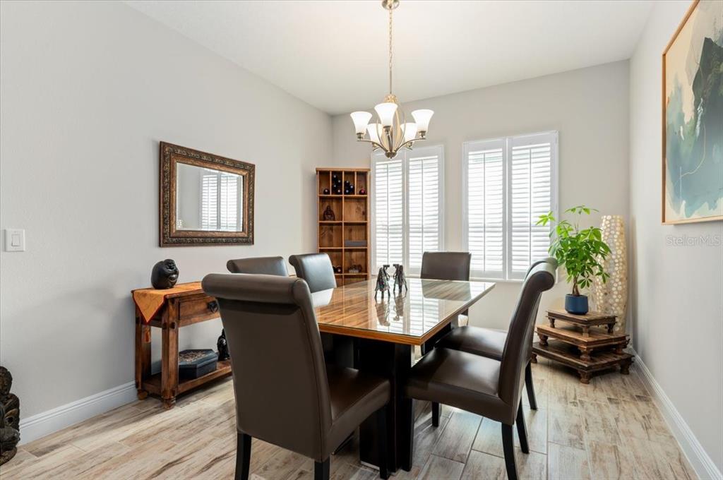 7440 Rhubarb Drive Parrish, FL 34219 - Photo 10 of 59 a view of a dining room with furniture window and wooden floor