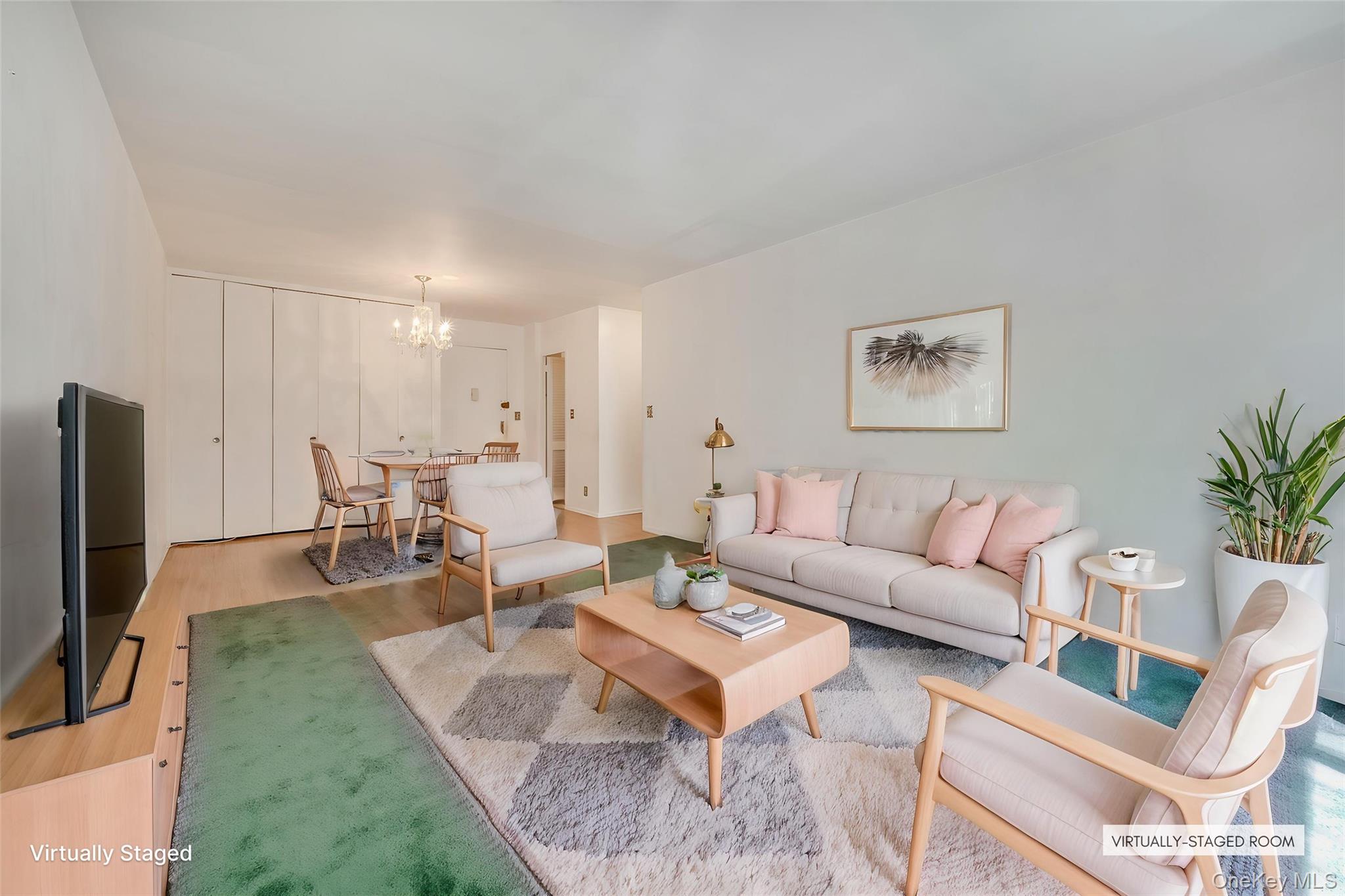 39-65 52nd Street, Unit 2H Queens, NY 11377 - Photo 2 of 18 a living room with furniture a flat screen tv and a fireplace