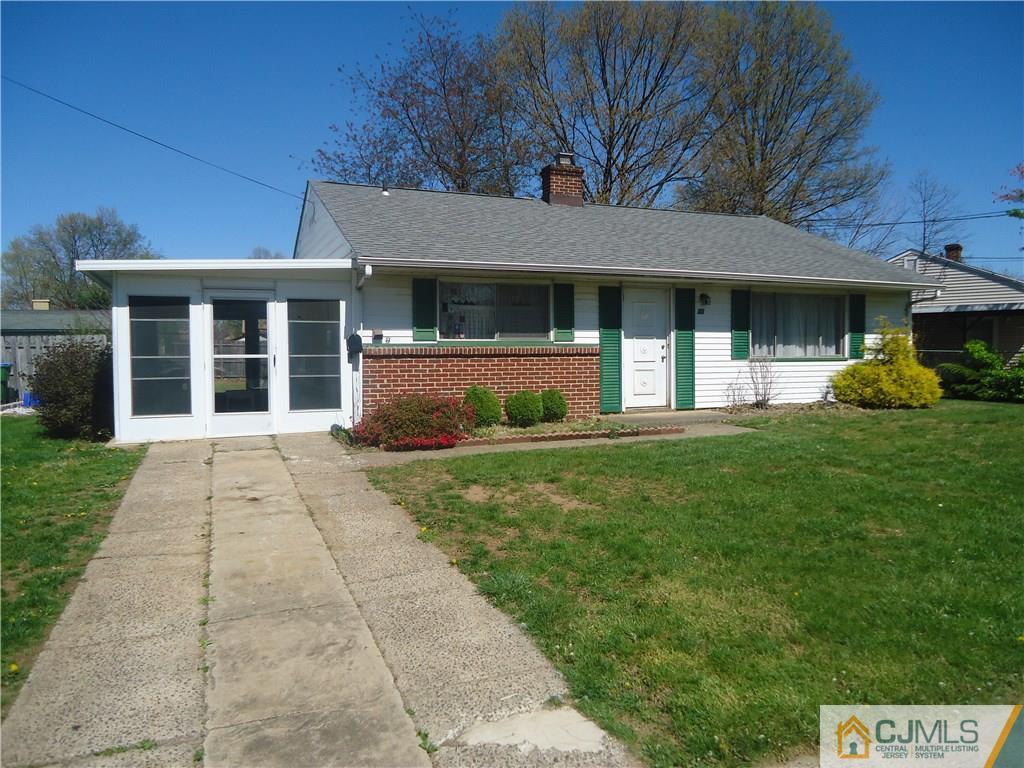 27 Comstock Road Edison, NJ 08817 - Photo 1 of 7 a front view of a house with garden