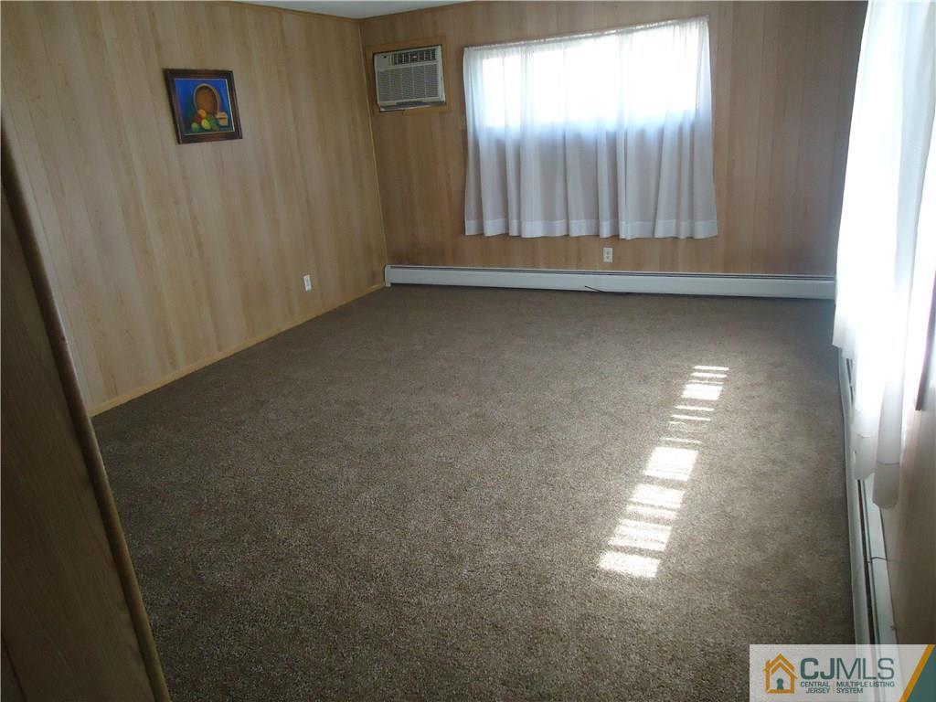 27 Comstock Road Edison, NJ 08817 - Photo 3 of 7 a view of an empty room and window