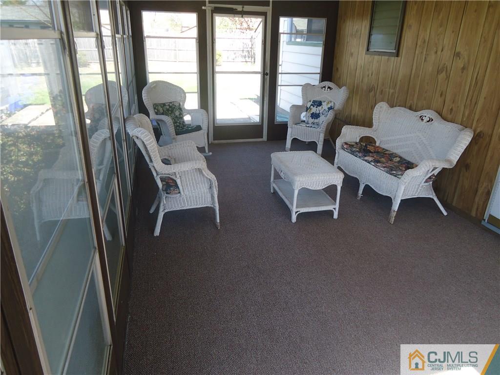 27 Comstock Road Edison, NJ 08817 - Photo 4 of 7 a living room with furniture and a floor to ceiling window