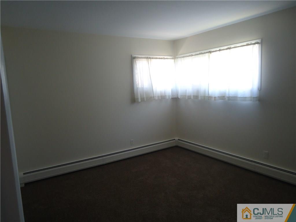 27 Comstock Road Edison, NJ 08817 - Photo 5 of 7 a view of an empty room with a window