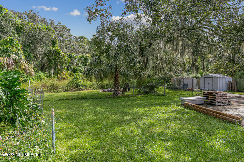 1807 Mill Creek Road Jacksonville, FL 32277 - Photo 16 of 18 a backyard of a house with table and chairs