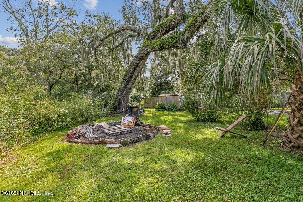1807 Mill Creek Road Jacksonville, FL 32277 - Photo 18 of 18 a backyard of a house with a table and chairs