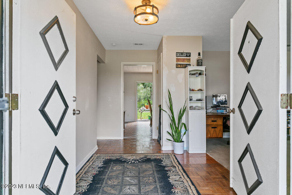 1807 Mill Creek Road Jacksonville, FL 32277 - Photo 3 of 18 a view of entryway with stairs and wooden floor