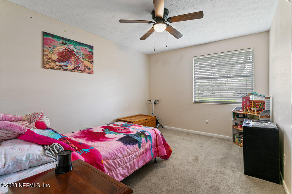 1807 Mill Creek Road Jacksonville, FL 32277 - Photo 9 of 18 a bedroom with a bed and wooden floor