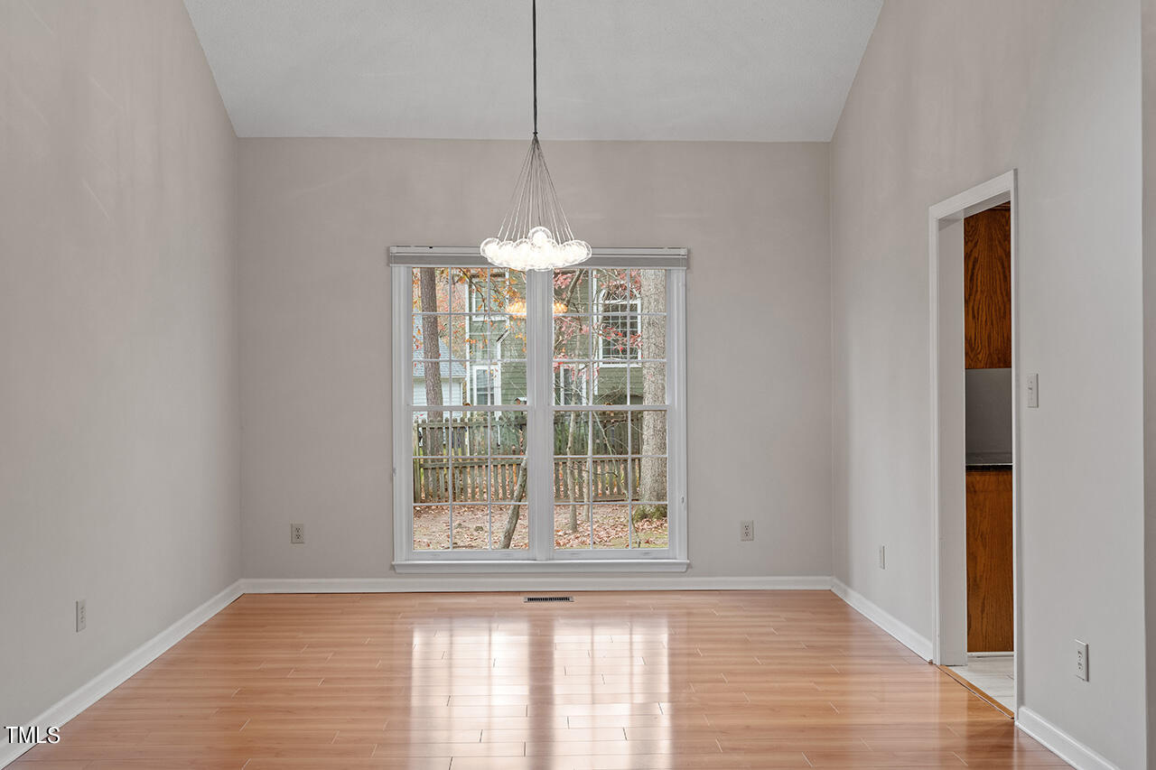 11932 North Exeter Way Raleigh, NC 27613 - Photo 13 of 35 a view of a room with a window and chandelier