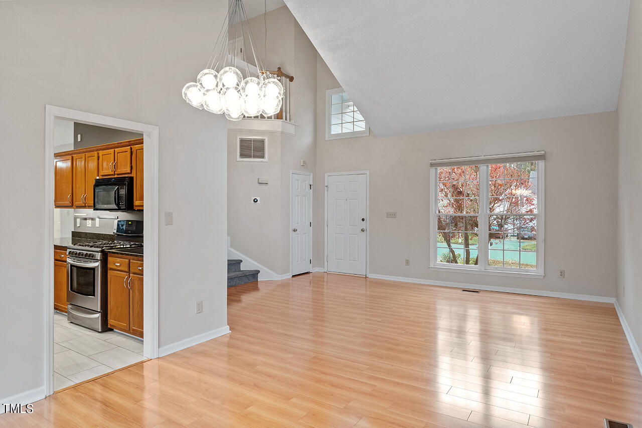 11932 North Exeter Way Raleigh, NC 27613 - Photo 14 of 35 a view of a kitchen with wooden floor and stainless steel appliances