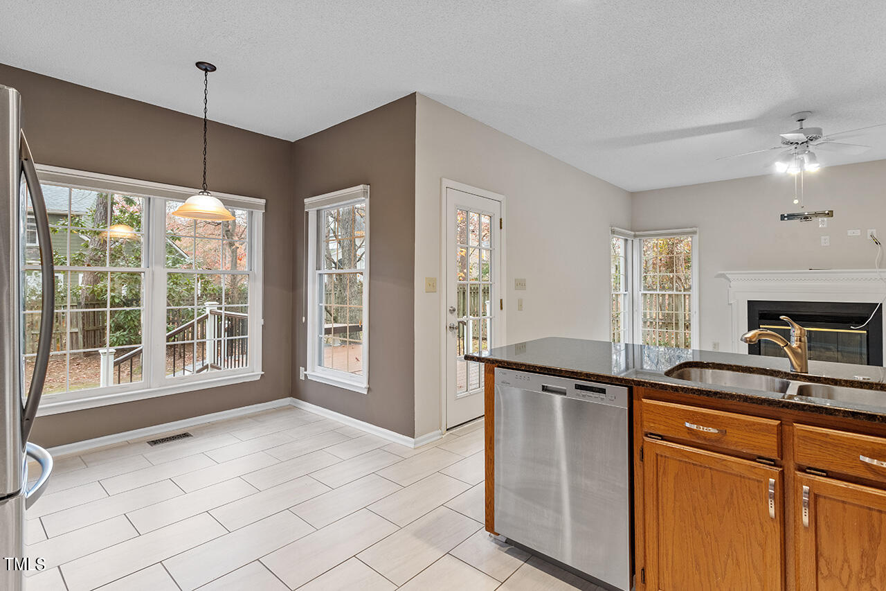 11932 North Exeter Way Raleigh, NC 27613 - Photo 16 of 35 a kitchen with stainless steel appliances granite countertop a sink and a stove