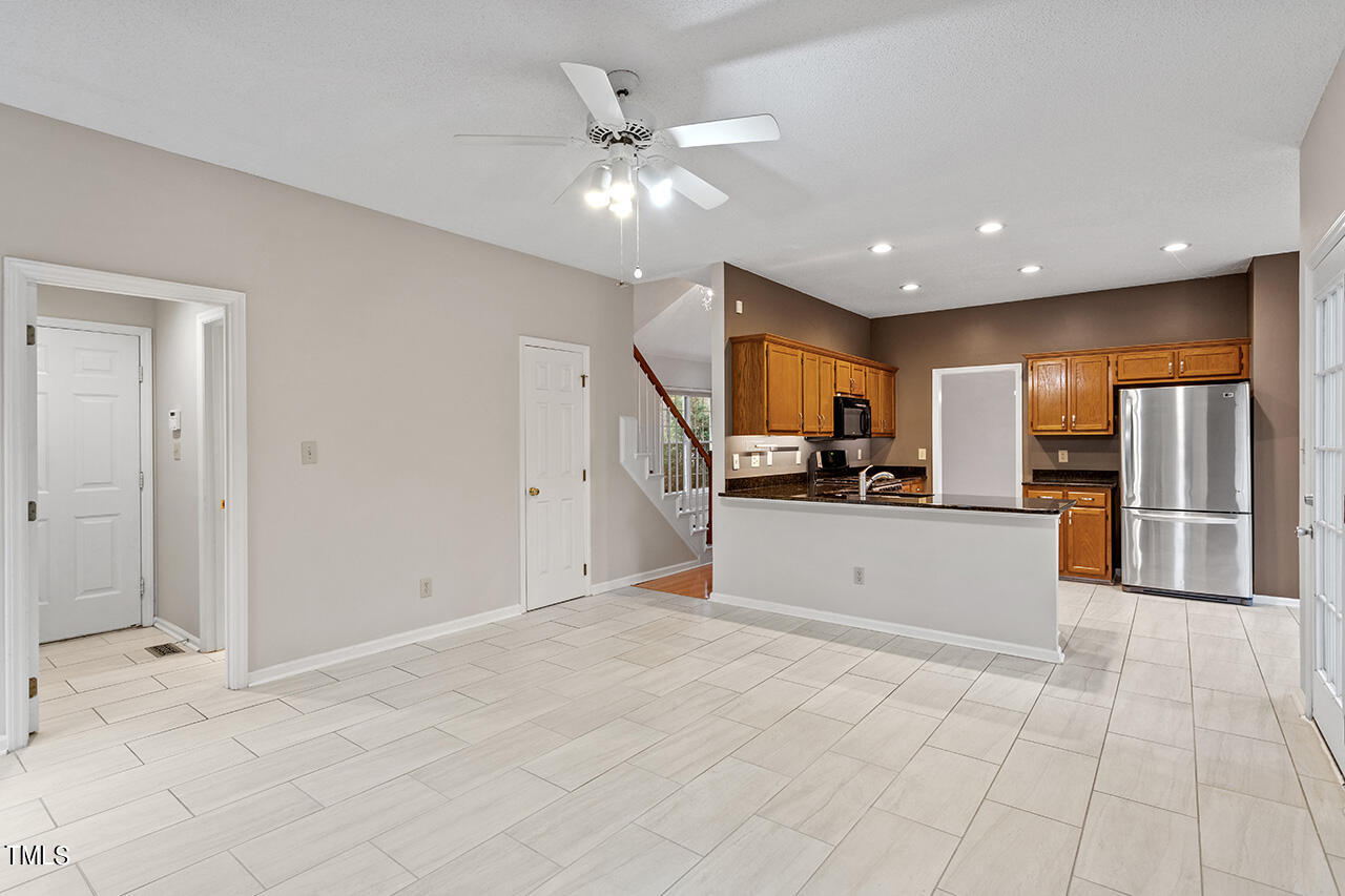 11932 North Exeter Way Raleigh, NC 27613 - Photo 23 of 35 a view of kitchen with stainless steel appliances kitchen island granite countertop a large counter top cabinets and stainless steel appliances