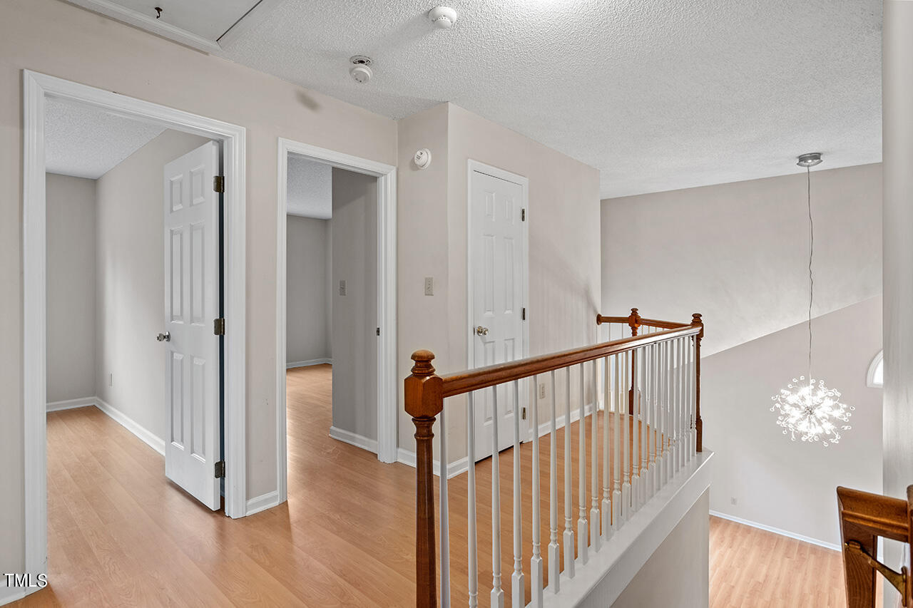 11932 North Exeter Way Raleigh, NC 27613 - Photo 27 of 35 a view of a hallway with entryway and wooden floor
