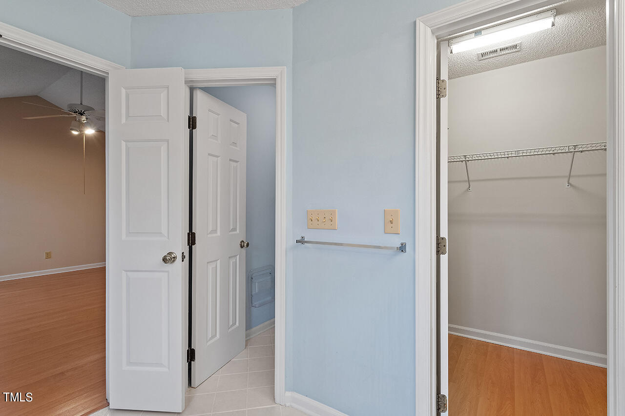 11932 North Exeter Way Raleigh, NC 27613 - Photo 32 of 35 a bathroom with a glass shower door