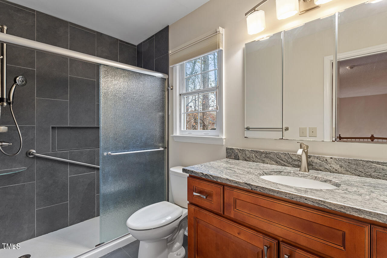 11932 North Exeter Way Raleigh, NC 27613 - Photo 33 of 35 a bathroom with a granite countertop sink toilet and shower