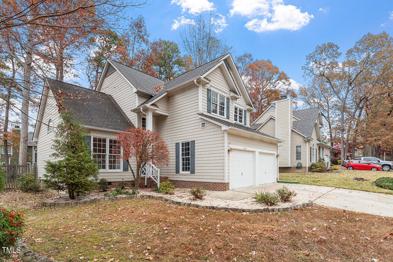 11932 North Exeter Way Raleigh, NC 27613 - Photo 4 of 35 a front view of a house with a yard