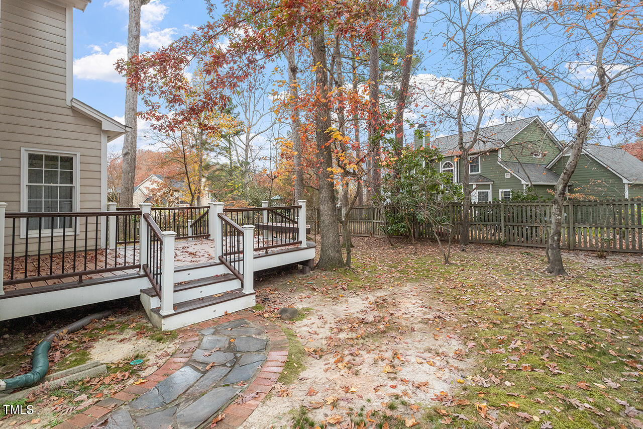 11932 North Exeter Way Raleigh, NC 27613 - Photo 6 of 35 a view of backyard with wooden fence and large trees