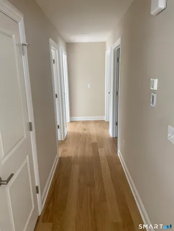 a view of a hallway with wooden floor