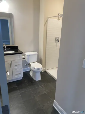 a bathroom with a toilet a sink and a shower