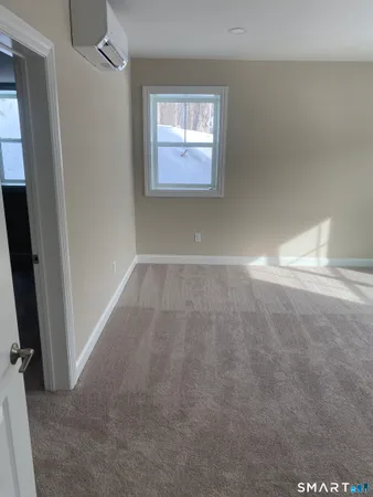 an empty room with windows and entrance