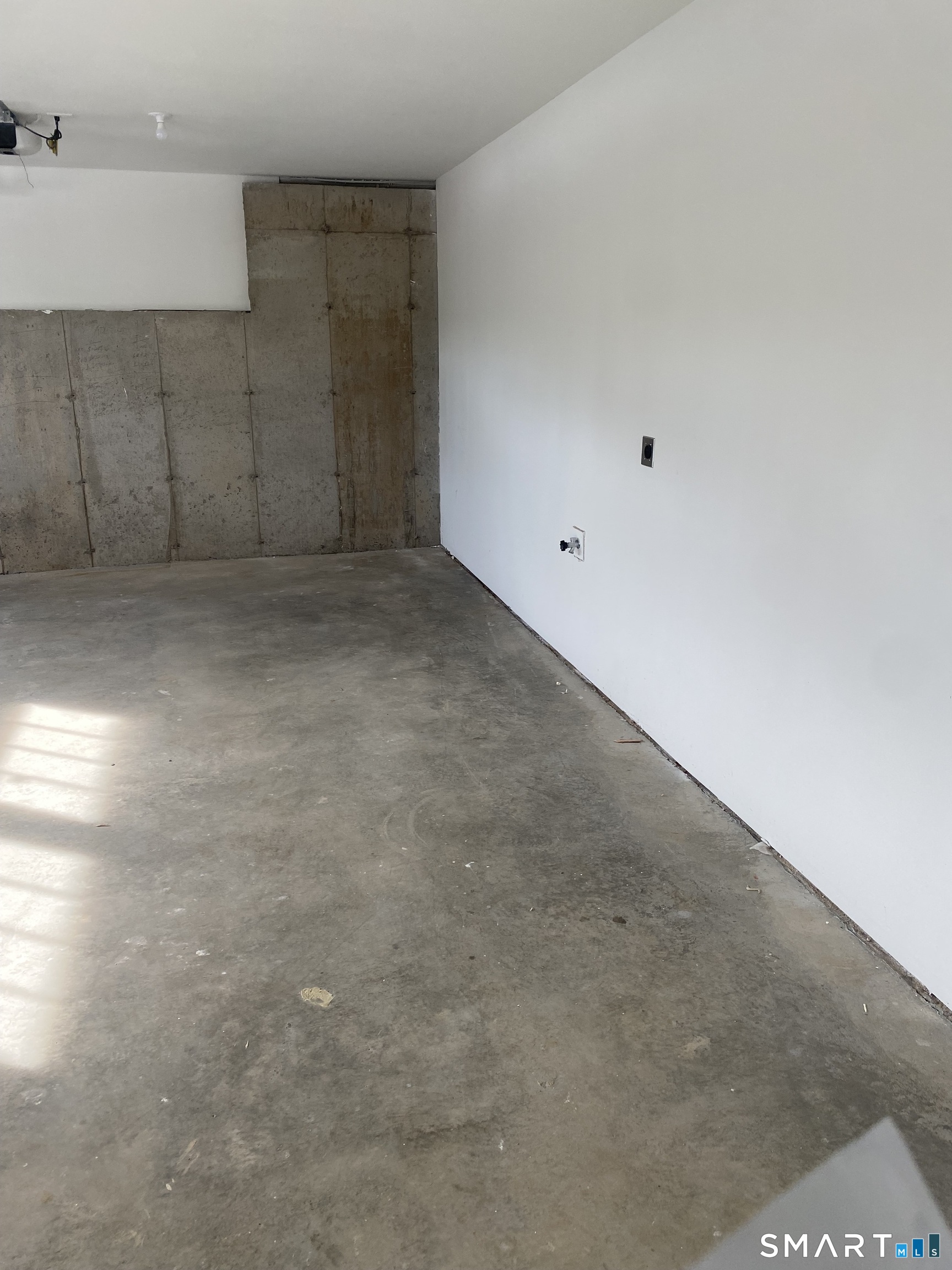 919 Strongtown Road Southbury, CT 06488 - Photo 39 of 40 Back of 2 car garage with water spigot. Looking from basement entrance.